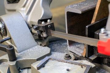 I-beam and band saw for metal with the sawn off part of the product - obrazy, fototapety, plakaty