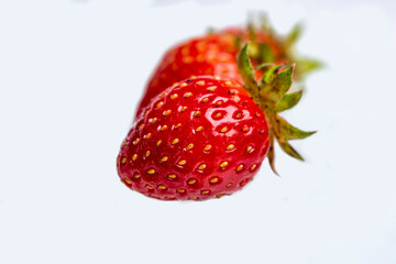 ripe red strawberry berry on a white background closeup