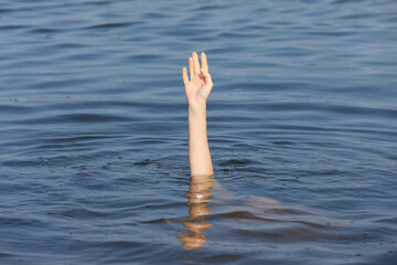 Drowning woman reaching for help in sea, closeup