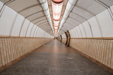 Tunnel of empty heptagonal long futuristic underpass, lined with  ceramic tiles.