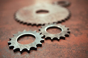 group of rusty metal gears on a metal surface