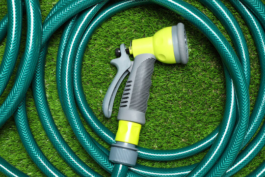 Watering Hose With Sprinkler On Green Grass, Top View