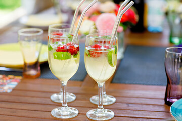 Cocktail Hugo with elderflowers, strawberries, lime and mint. Fresh summer barbecue drink for parties.