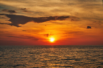 red twilight sky of sunset scene with cloudy sky over the open ocean with many waves