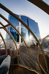 Original rooftop cafe overlooking city. igloo with tables for dinner or date.