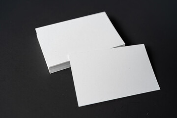 Pile of white blank space business name cards stack template for advertise and marketing on wooden texture background, clipping path for insert your banner text design for present the company brand