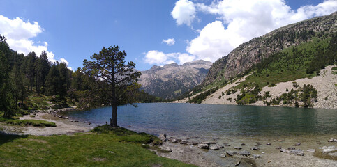 Landscape in the National Park of Aigüestortes and Lake San Mauricio. View of the Lake Llong and glacier lateral moraine. Pyrenees Mountains. Catalonia. Spain.
