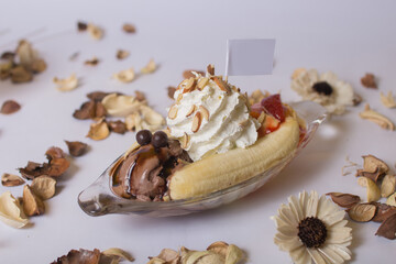 Banana boat ice cream on plane background.