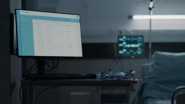 Nobody in empty hospital ward bed at medical clinic with modern technology equipment for treatment including stethoscope, files information computer, oxygen tube and heart rate monitor