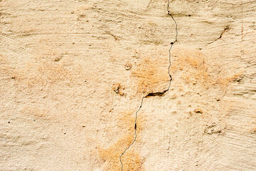 Texture of a concrete wall with cracks and scratches which can be used as a background