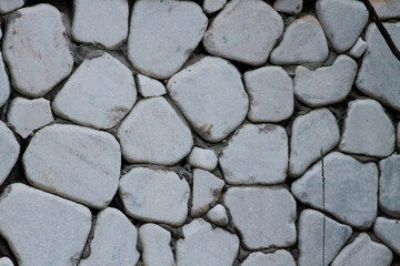 Wall cladding made using white, rounded white stones