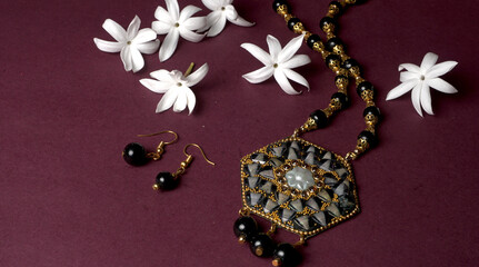 Indian traditional antique or retro style pendant on black background.
