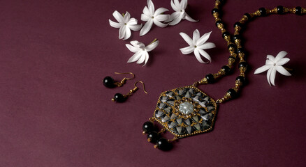 Indian traditional antique or retro style pendant on black background.
