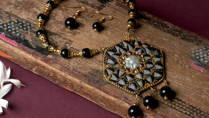 Indian traditional antique or retro style pendant on black background.
