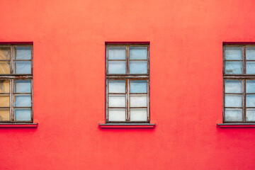 Fototapeta na wymiar Red house facade with wooden windows