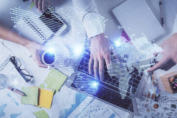 Double exposure of man's hands typing over computer keyboard and social network theme hologram drawing. Top view. People connection web concept.