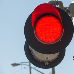 red traffic light at a railway crossing