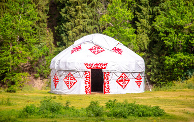 Yurt. National ancient house of the peoples of Kazakhstan and Asian countries. National Housing. Yurts on the background of a green meadow and highlands.