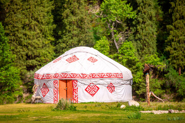 Yurt. National ancient house of the peoples of Kazakhstan and Asian countries. National Housing. Yurts on the background of a green meadow and highlands.