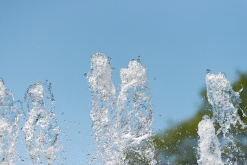 water flowing from a fountain against a blue sky