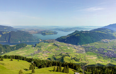 Fototapeta na wymiar Magnificent panoramic aerial views of central Switzerland, mountains, villages and Lake Lucerne as you ascend the Cabrio cable car up Mount Stanserhorn in Switzerland. City of Stans.