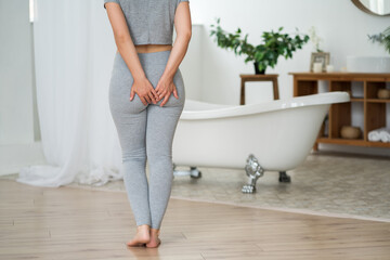 Anal pain, woman suffering from hemorrhoids