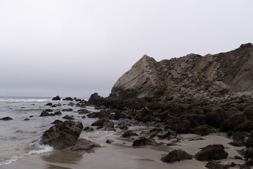 Fototapeta na wymiar Jagged Rocks with a light Fog off the beach of the Pacifica Coast