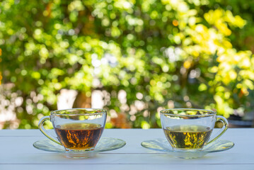 cups of green and chinese tea served on white table in garden