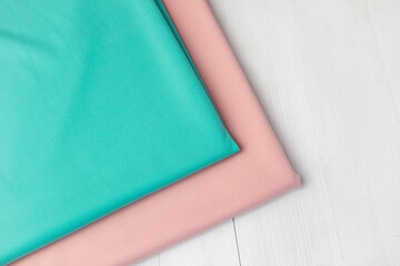 Mint and pink jersey fabric. Cut for clothes on a white background