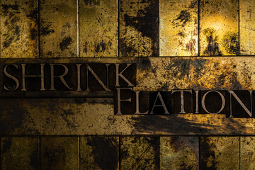 Shrinkflation text on vintage textured grunge copper and gold background
