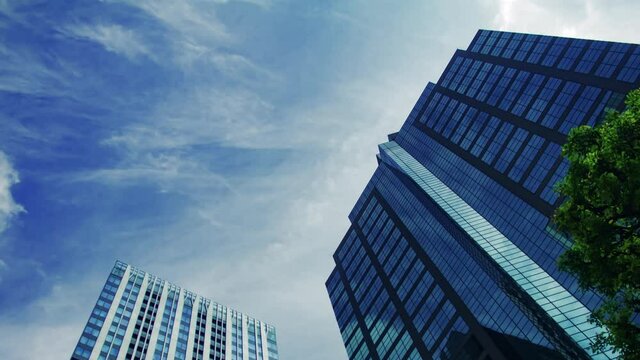 A timelapse of clowd at the building in the business town wide shot panning
