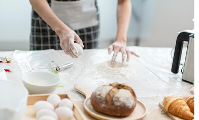 Obraz na płótnie Canvas Hands knead the dough to make homemade cakes in the kitchen. 