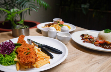 Sirloin steak, catfish and chips, and chicken black pepper. Food menu on the table