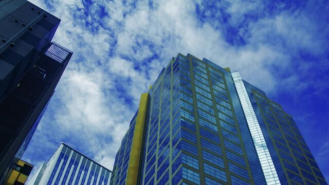 A timelapse of clowd at the building in the business town wide shot panning
