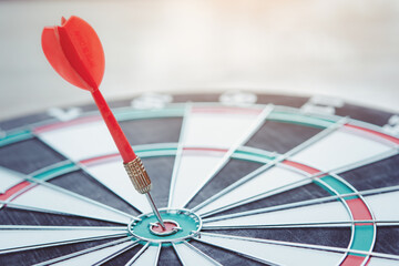 Business marketing success concept. Red dart arrow in center of the target dartboard. Bullseye is a...