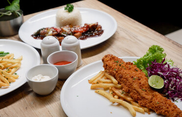 Sirloin steak, catfish and chips, and chicken black pepper. Food menu on the table