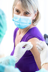 Women wearing masks getting vaccinated. Concept of coronavirus, vaccination elderly woman mask who...