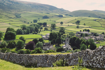 Fototapeta premium A view looking south over towards Burnsall and Thorpe Fell, in the Yorkshire Dales, North Yorkshire.
