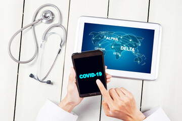 Male doctor hands touching covid-19 word