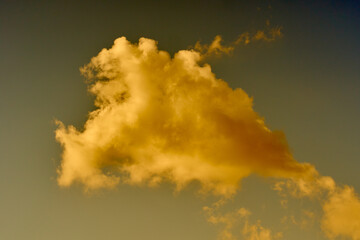 Colorful clouds in the blue summer sky at sunset time. Abstract nature background.
