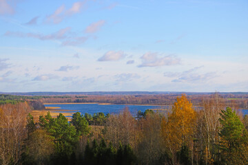 Naklejka na ściany i meble View from the height of the lake and forest in autumn.