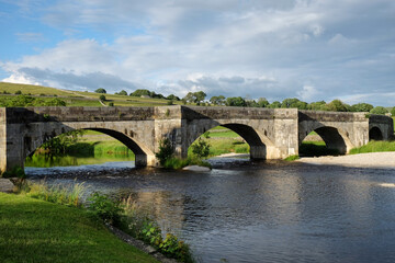 Fototapeta na wymiar Burnsall Bridge over the River Wharfe, in the Yorkshire Dales, North Yorkshire.
