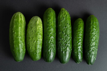 Fresh cucumbers on dark background
