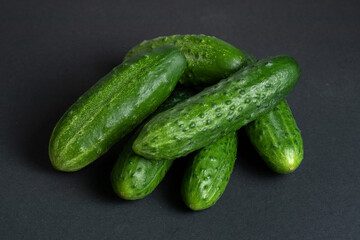 Fresh cucumbers on dark background