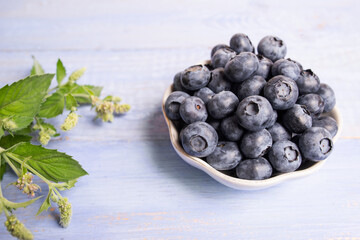 fresh ripe blueberries on a blue wooden table. Useful vitamins and minerals