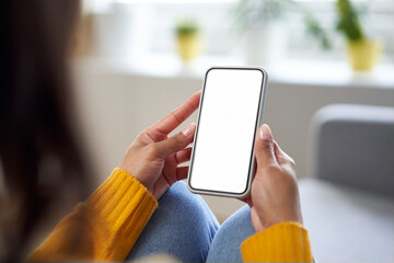 Smartphone mockup. Closeup of woman using mobile phone with empty screen at home - Powered by Adobe