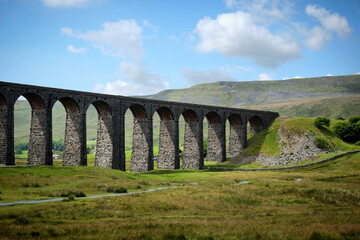Fototapeta na wymiar A view of the Ribblehead Viaduct and Whernside Peak, Ribblesdale in the Yorkshire Dales, North Yorkshire.