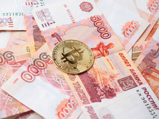 the bitcoin coin lies on the background of Russian rubles. Cryptocurrency mining and Mining Concept