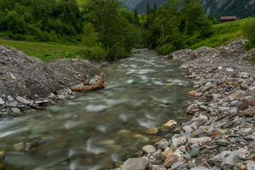 Valley with color small river in Austria Alps mountains