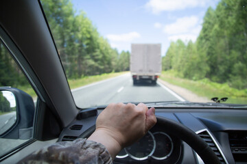 Overtaking a car.A dangerous maneuver on the road.Driving a car.